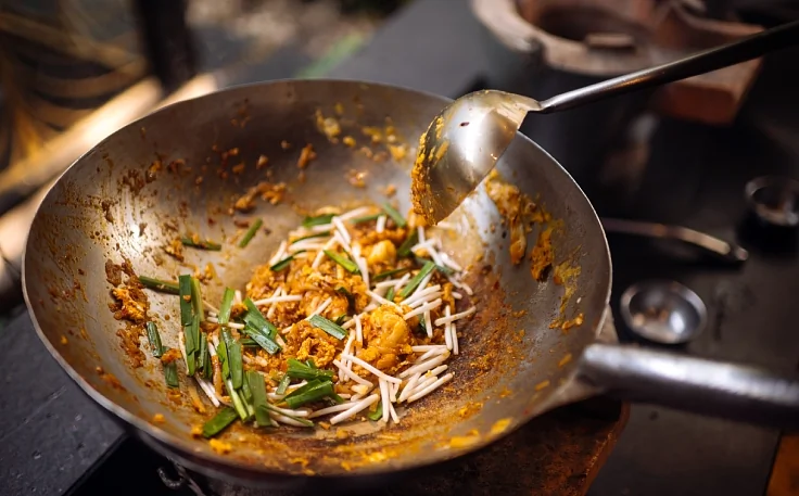 Sauter les nouilles de riz dans un wok très chaud