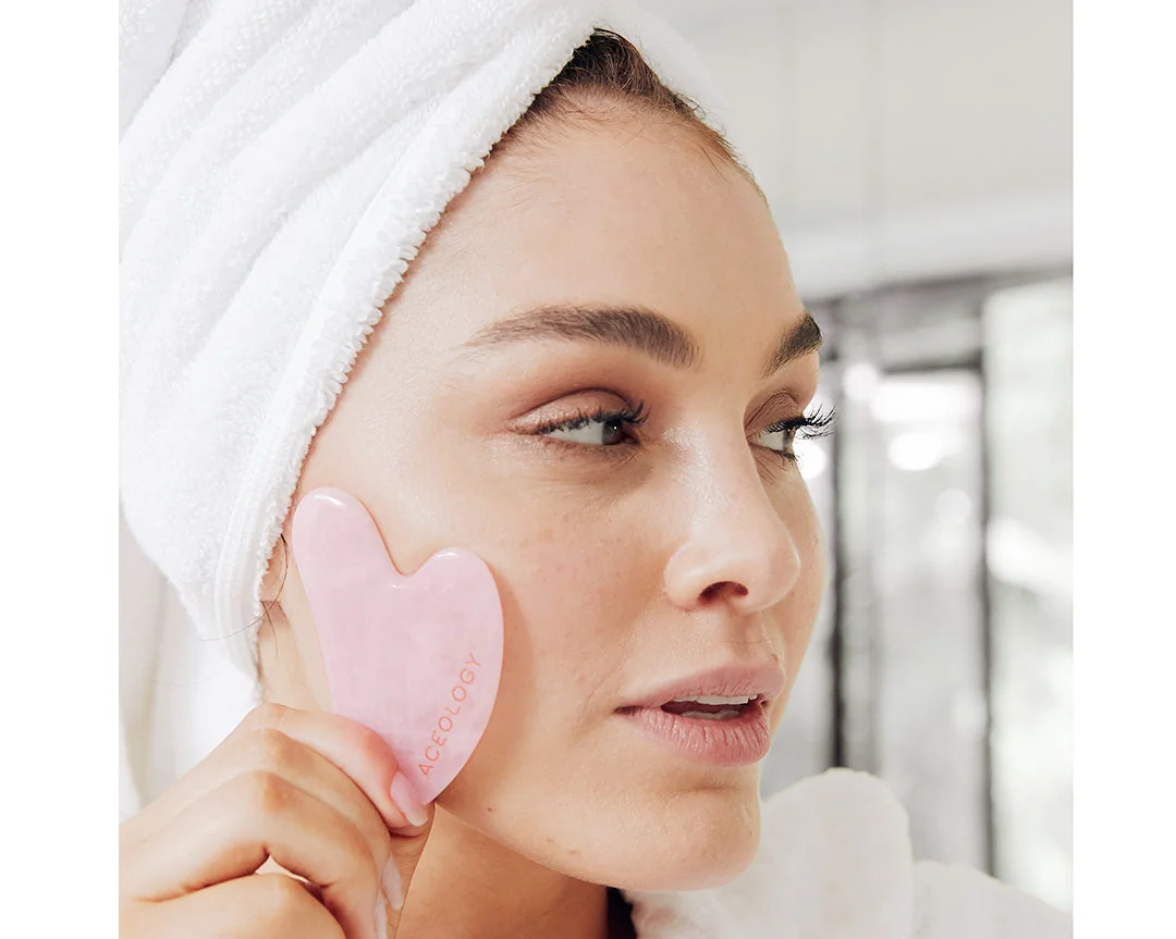 Utilisation d'un gua sha en quartz rose pour obtenir l'effet Glass Skin du layering coréen.